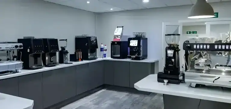 Coffee vending machines in a modern break room setup.